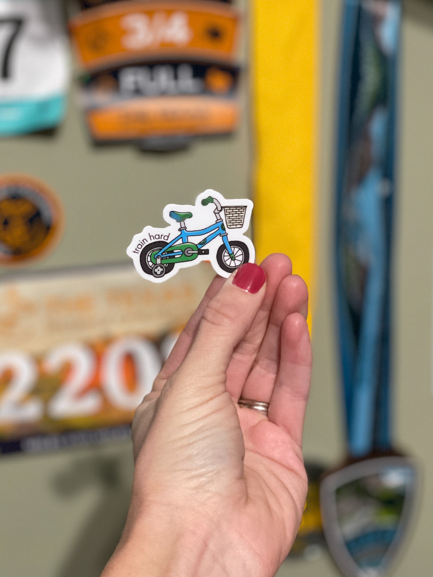 Blue and green tricycle sticker with punny saying, train hard on the front. Durable enough for cyclist, mountain biker, gravel bike, zwift, peleton, triathlon. Vinyl sticker for hydroflask, nalgene, yeti, laptop, window