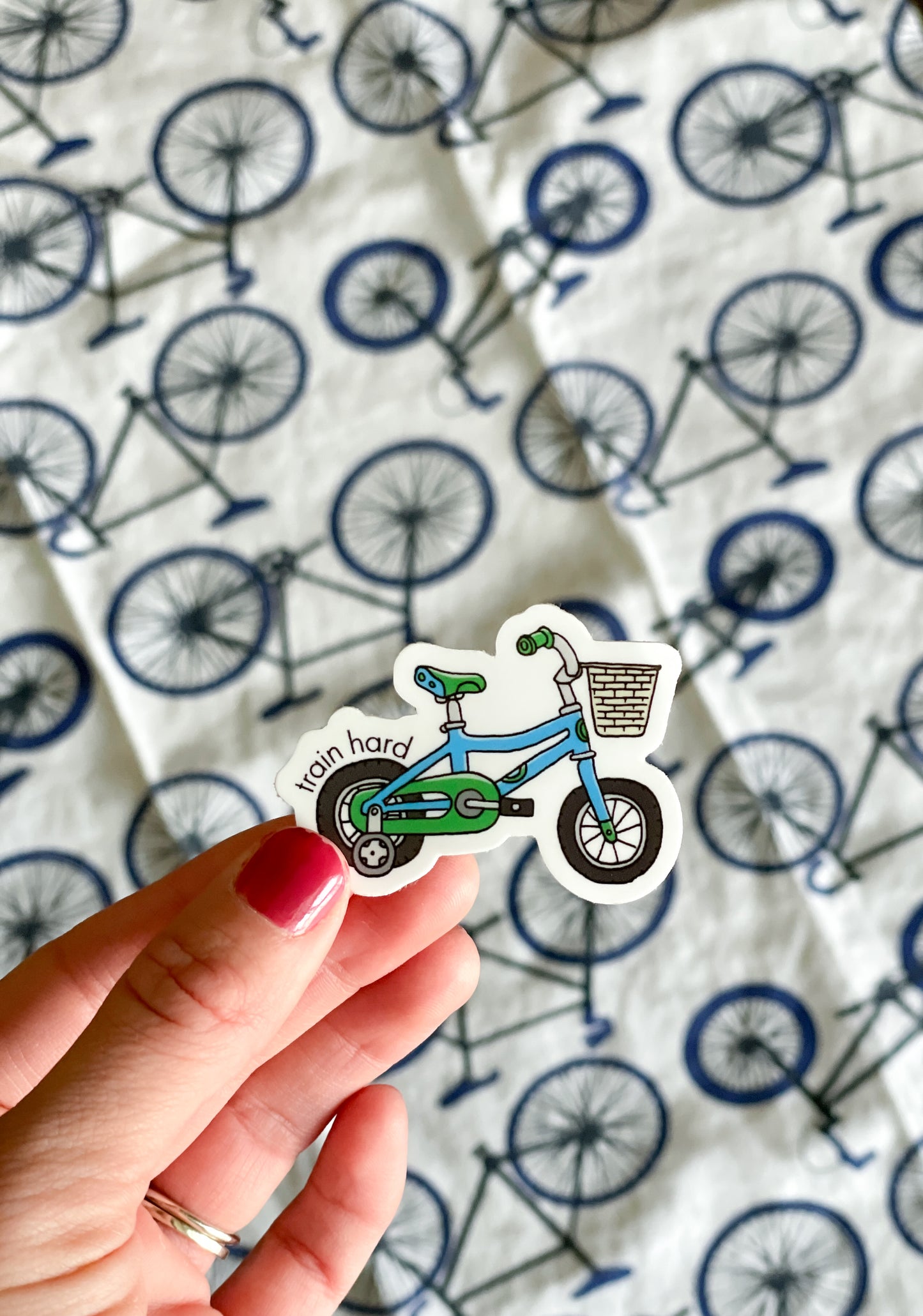 Blue and green tricycle sticker with punny saying, train hard on the front. Durable enough for cyclist, mountain biker, gravel bike, zwift, peleton, triathlon. Vinyl sticker for hydroflask, nalgene, yeti, laptop, window